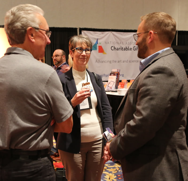 Larry and Nathan speak with a client at CGP 2018.