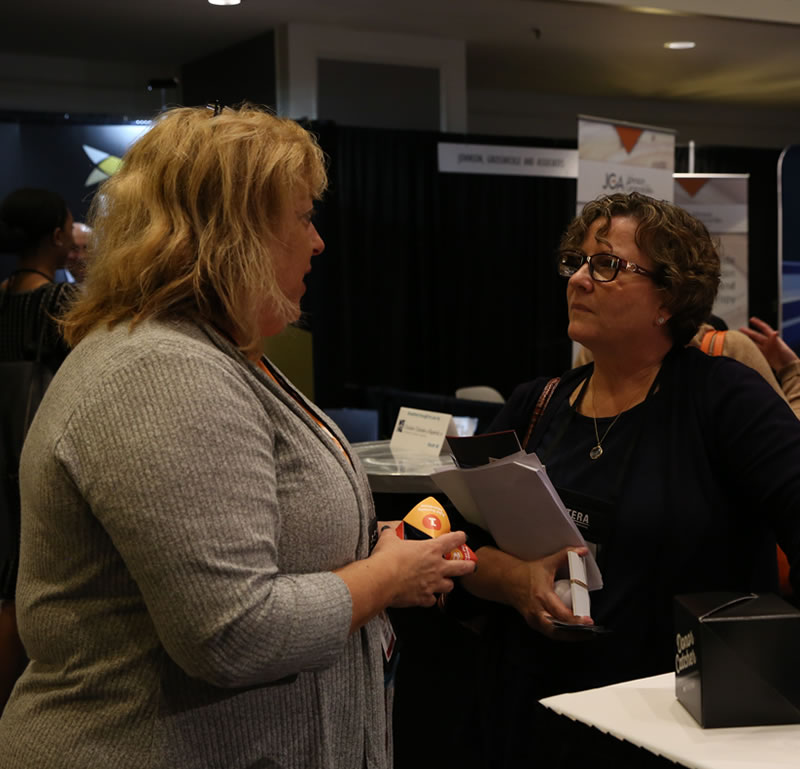 Kelly Benson speaks with a client at the 2019 NCPP Conference.