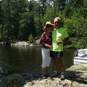 Peggy and Larry standing next to a lake