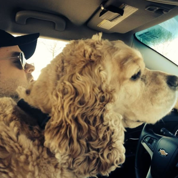 Ben driving with his dog.